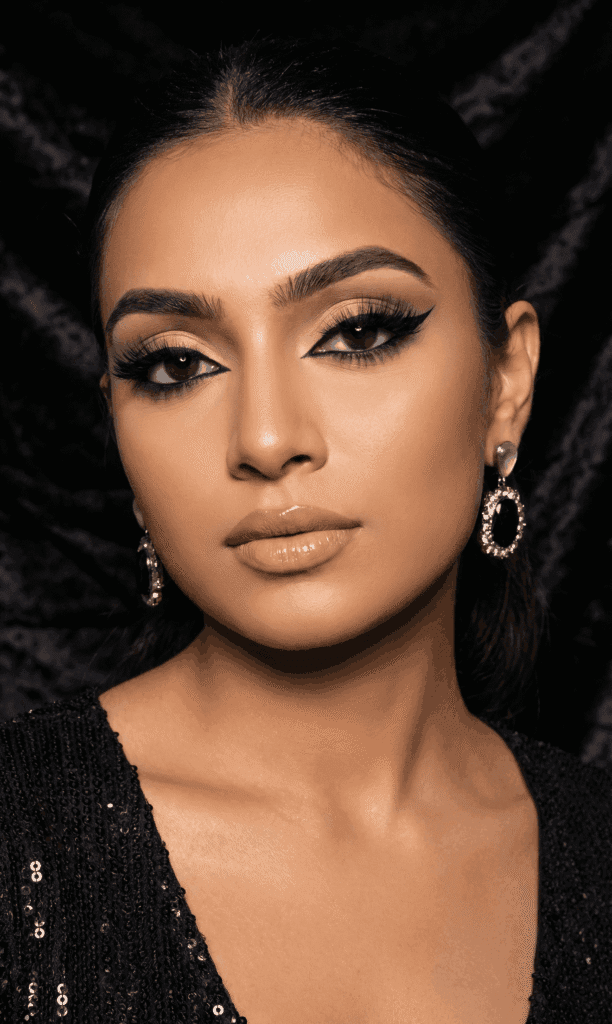 Woman with bold black smokey eye makeup for night party look.